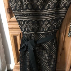 Black strapless lace dress with beige undertone.